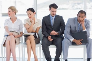 Four business people waiting for job interview in a bright office